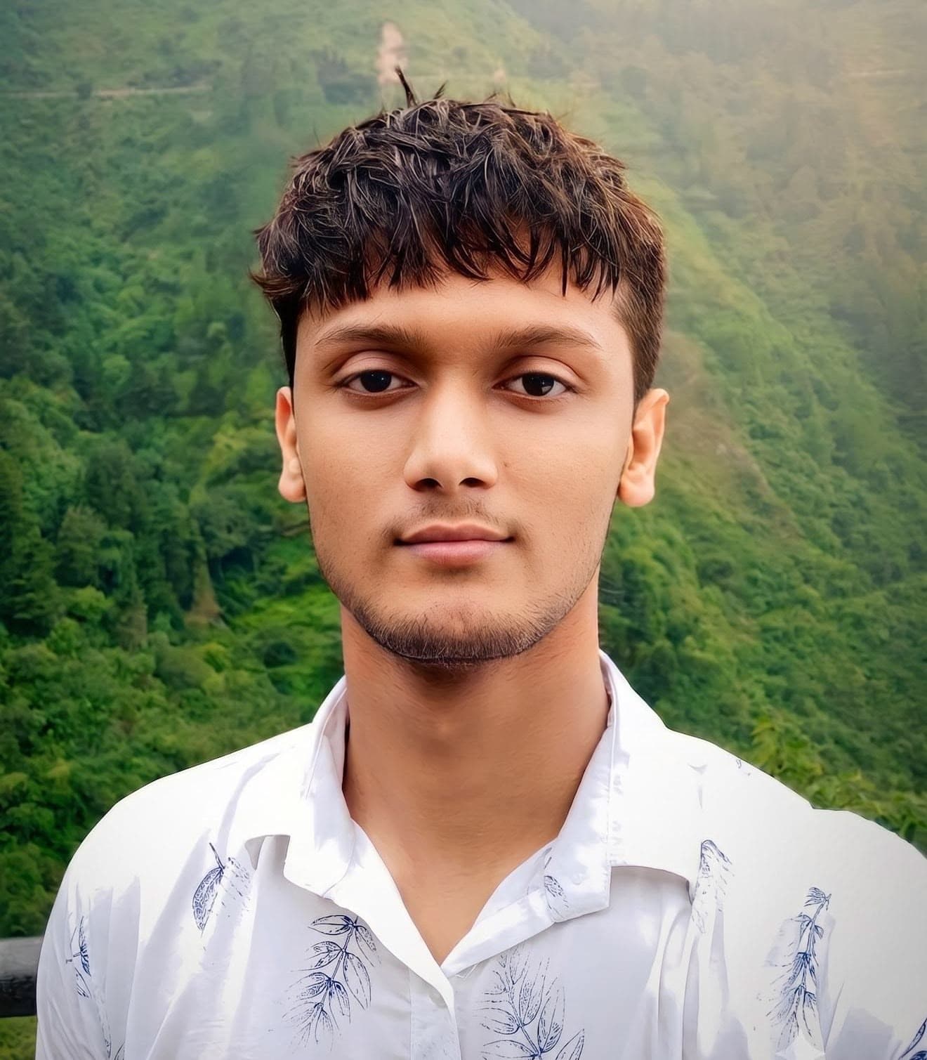 Aayush Bharti standing in the green mountains